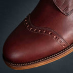 Officer Boot in Oxblood, angled close-up of toe cap brogue detail and stitched welt