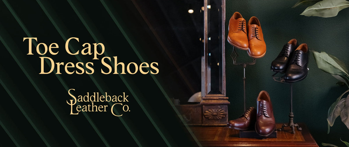 Toe Cap Dress Shoes, Saddleback Leather Co. Three pairs of toe-cap oxfords — tan, black and dark brown — displayed on stands against a dark green wall.