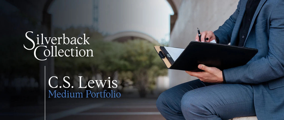 C.S. Lewis Medium Portfolio in Raven Black open on a seated man's lap, banner text Silverback Collection C.S. Lewis