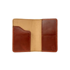 Slim Passport Wallet in Chestnut opened flat to show the passport sleeve, card pockets and tan interior