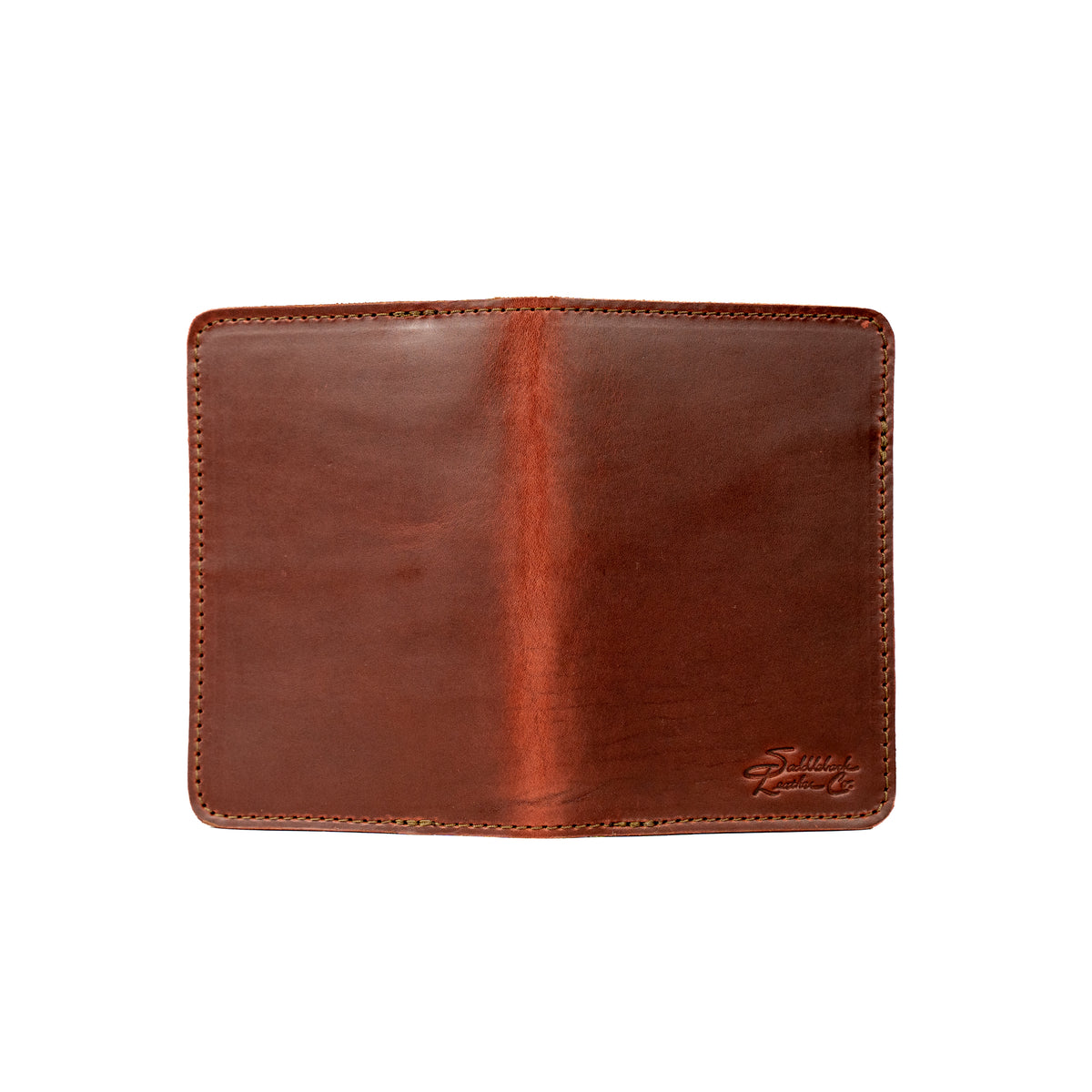 Slim Passport Wallet in Chestnut opened flat face down, showing the full outer cover and embossed logo