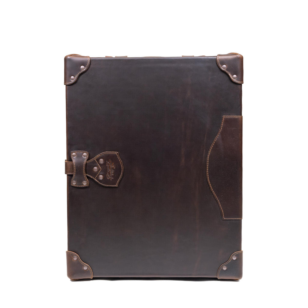 Leather Small Trunk in Dark Coffee Brown, closed and upright, front view showing latch, outer pocket and corner guards