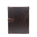 Leather Small Trunk in Dark Coffee Brown, closed and upright, front view showing latch, outer pocket and corner guards