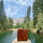 Large Bifold Wallet in Tan, well-worn wallet standing on a log by a mountain river