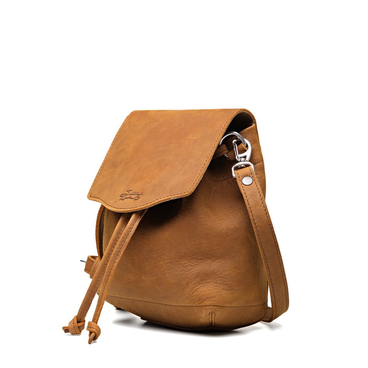 Mini Bucket Bag in Tobacco, angled side view with flap, drawstring and strap clip