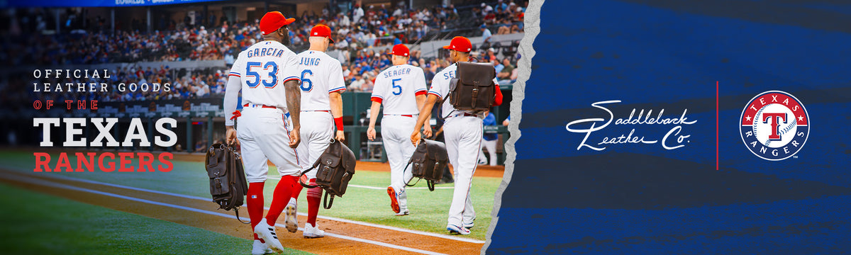 Official Leather Goods of the Texas Rangers: Rangers All-Stars Garcia, Jung, Seager and Semien walk off the field carrying leather backpacks, beside the Saddleback Leather Co. and Texas Rangers logos.