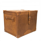 Leather Small Trunk in Tobacco, closed angled view with buckled strap, side handle and leather corner guards