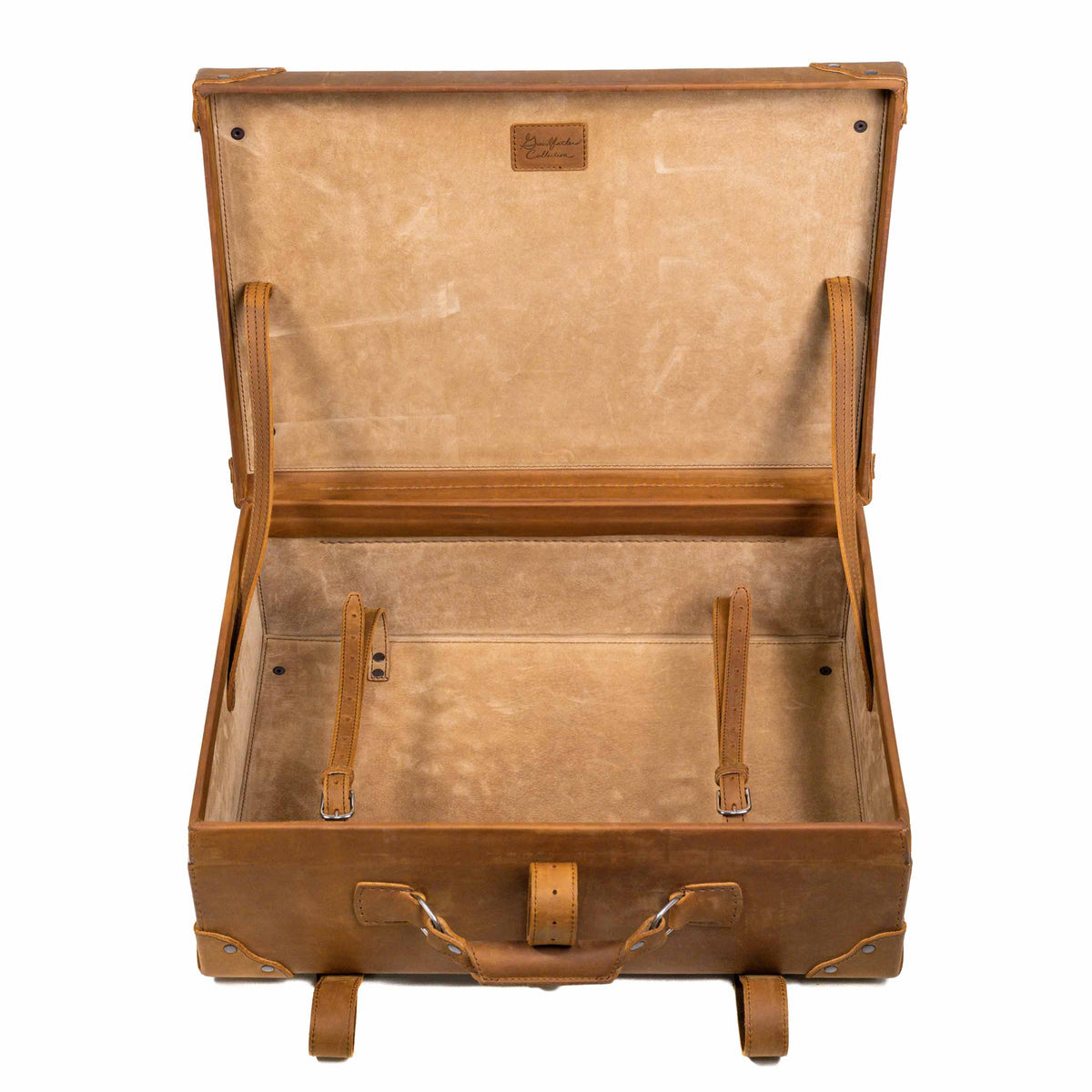 Grandfather Medium Suitcase in Tobacco, opened to show the canvas lining and leather tie-down straps