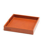 The Simple Leather Valet Tray in English Tan, empty, angled view showing stitched corner seams and embossed logo