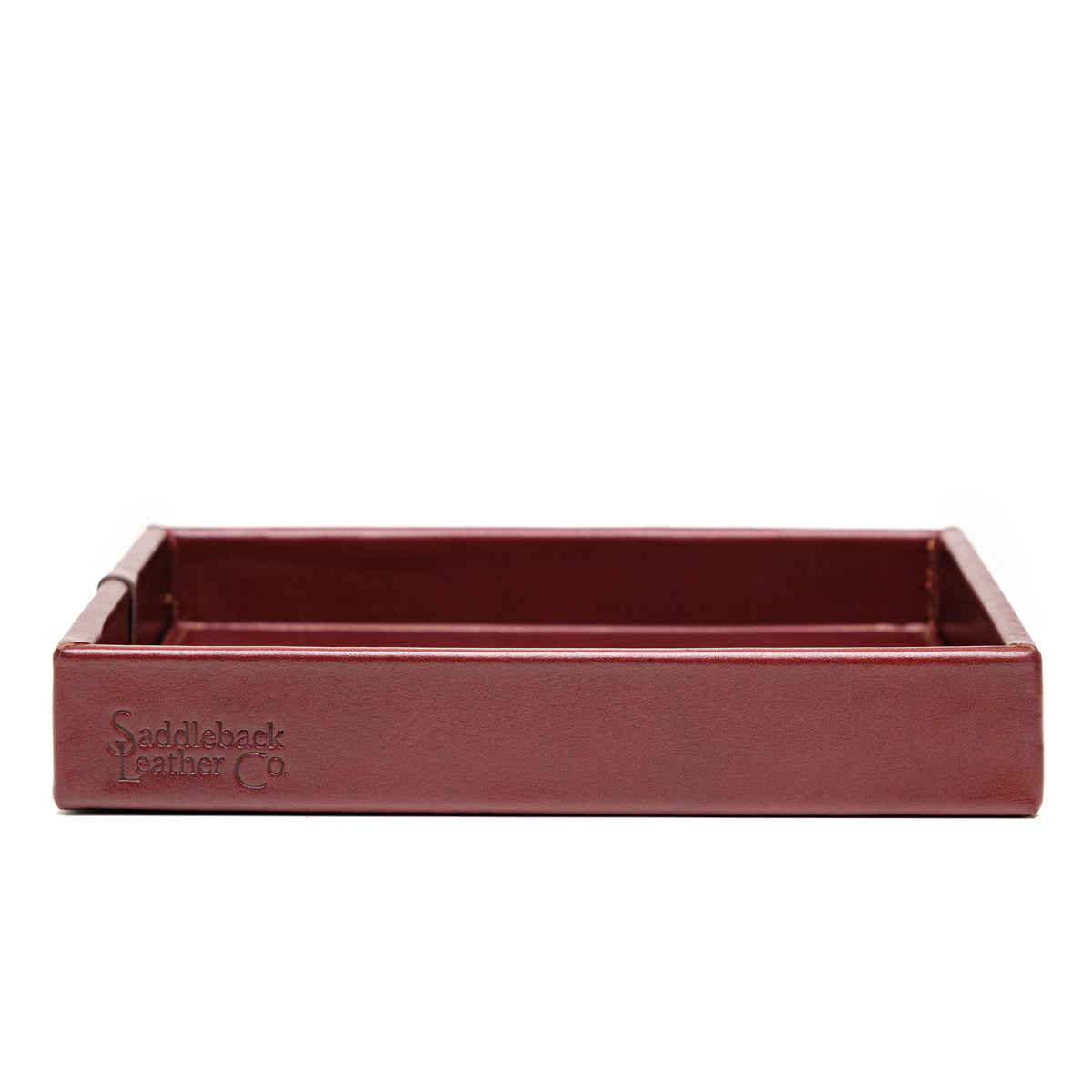 The Simple Leather Valet Tray in Oxblood, straight-on side view showing embossed Saddleback Leather Co. logo