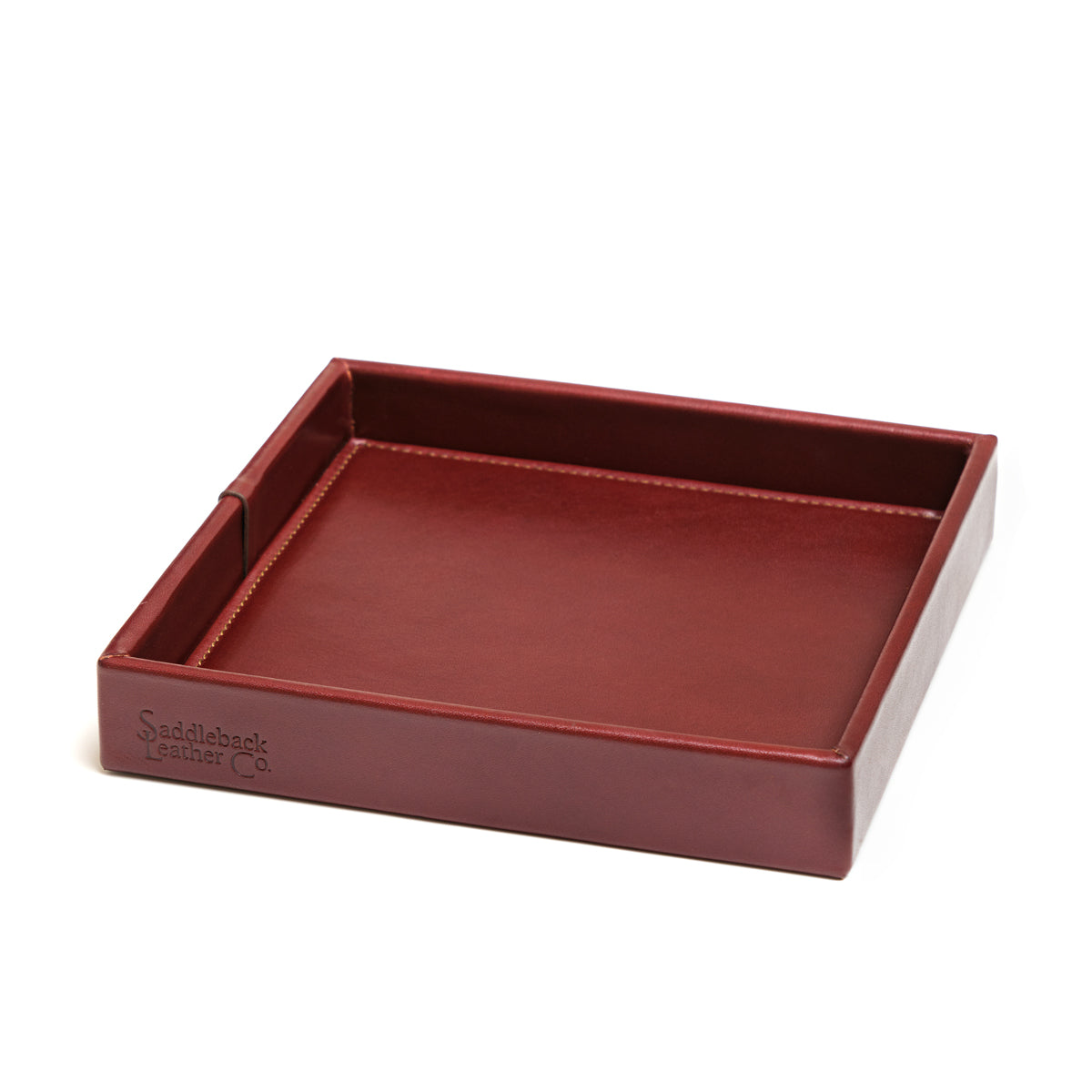 The Simple Leather Valet Tray in Oxblood, empty, angled view showing stitched corner seams and embossed logo