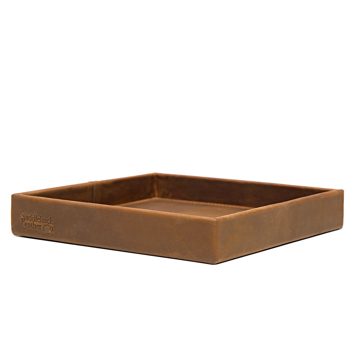 The Simple Leather Valet Tray in Tobacco, empty, low side view with embossed logo on the front edge